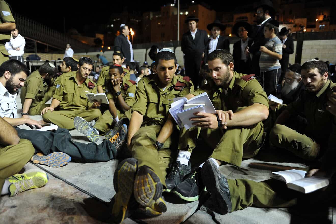 IDF soldiers sit on the ground during Tisha B'Av prayers at the Western Wall in the Old City of Jerusalem, July 16, 2013. Photo by Mendy Hechtman/Flash90.