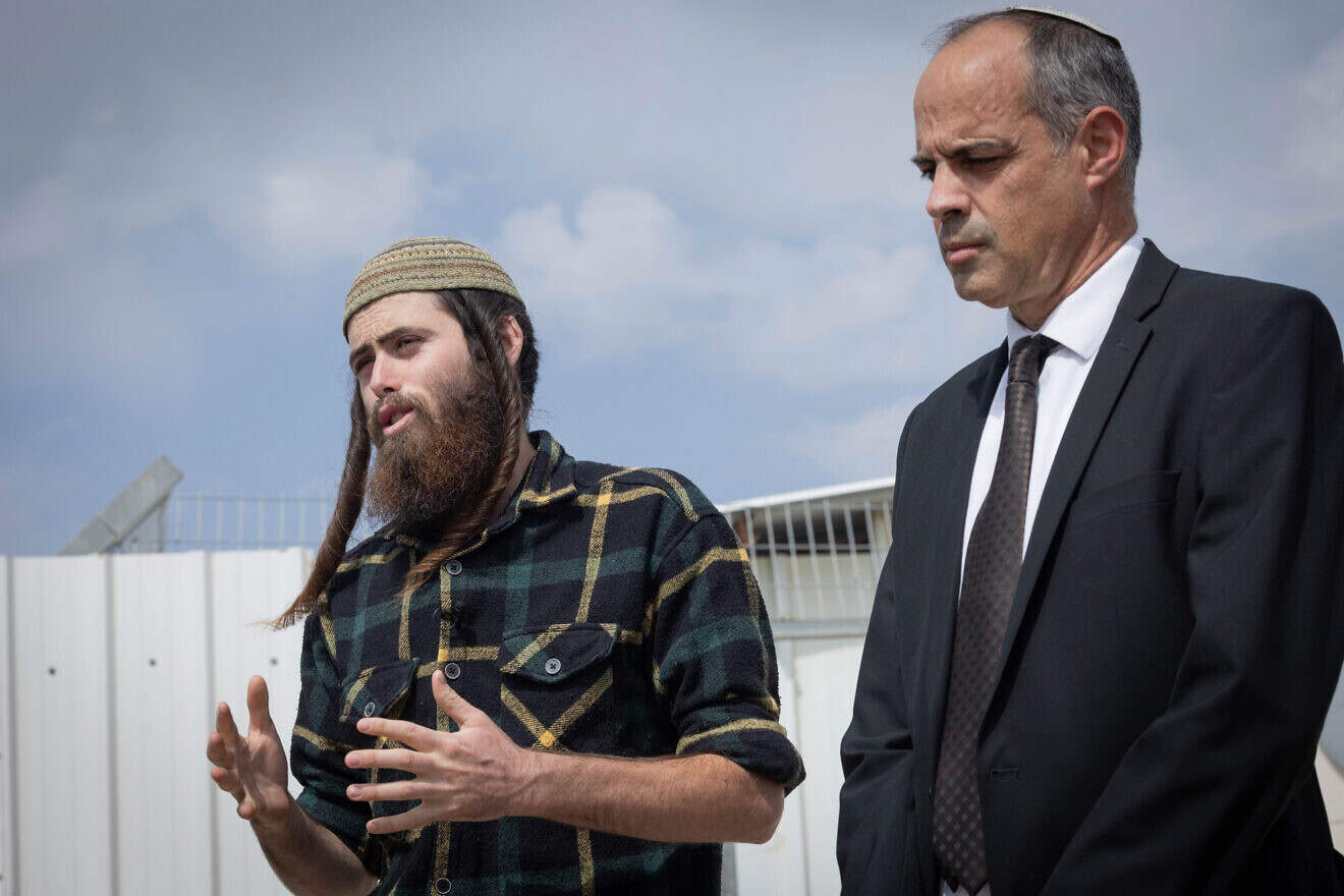 Elisha Yered (left), who was briefly detained on charges of involvement in the death of a Palestinian in Samaria, and his attorney outside the Ofer military court, Oct. 5, 2023. Photo by Chaim Goldberg/Flash90.