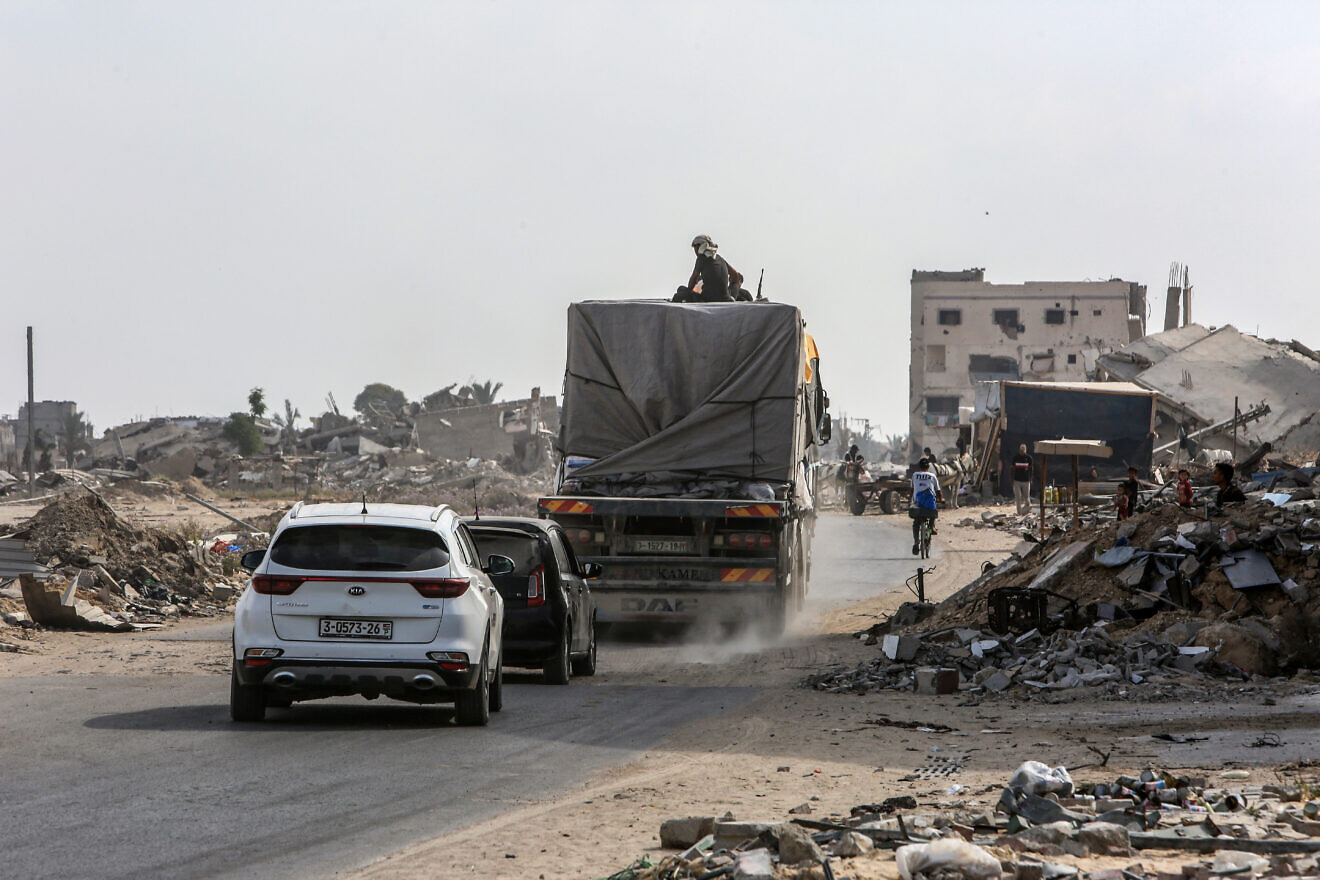 Palestinians seen on trucks loaded with aid entering Gaza through the Israeli Kerem Shalom Crossing, in the southern Gaza Strip, July 1, 2024. Photo by Abed Rahim Khatib/Flash90.