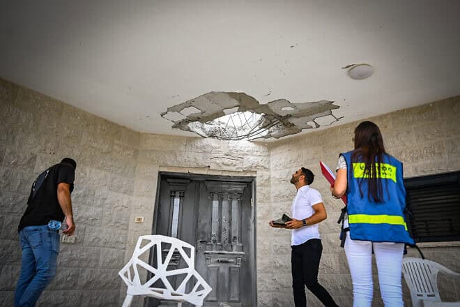 People at the site of a damaged house following a missile attack from Lebanon, in Moshav Manot, northern Israel, Aug. 25, 2024. Photo by Flash90.