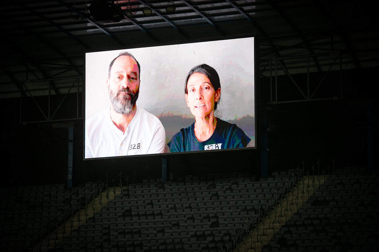 Jonathan Polin and Rachel Goldberg-Polin, parents of hostage Hersh Goldberg-Polin, seen on a screen during the Israeli Premier League match between Hapoel Hadera and Hapoel Jerusalem at the Teddy Stadium in Jerusalem, Aug. 31, 2024. Photo by Oren Ben Hakoon/Flash90.