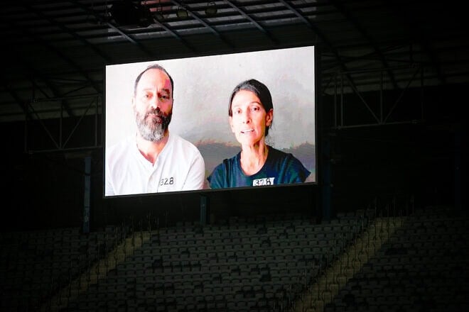 Jonathan Polin and Rachel Goldberg-Polin, parents of hostage Hersh Goldberg-Polin, seen on a screen during the Israeli Premier League match between Hapoel Hadera and Hapoel Jerusalem at the Teddy Stadium in Jerusalem, Aug. 31, 2024. Photo by Oren Ben Hakoon/Flash90.