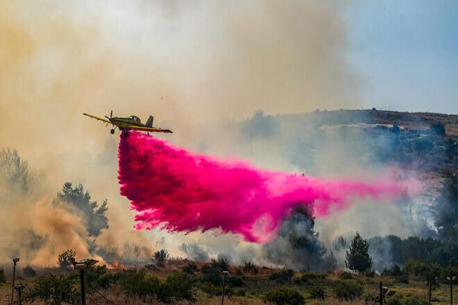 A firefighting plane tries to extinguish a large fire after missiles launched from Lebanon hit open areas near Kadita, close to Safed in the Galilee, June 12, 2024. Photo by Ayal Margolin/Flash90.