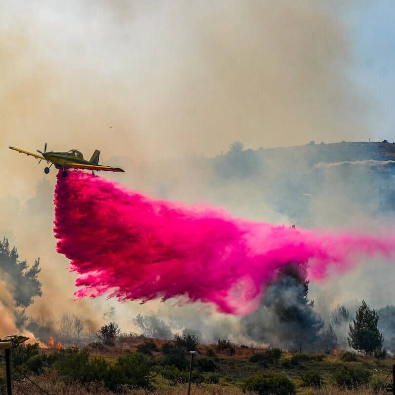 A firefighting plane tries to extinguish a large fire after missiles launched from Lebanon hit open areas near Kadita, close to Safed in the Galilee, June 12, 2024. Photo by Ayal Margolin/Flash90.