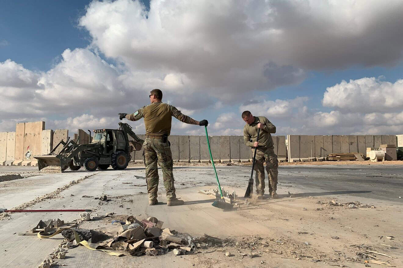 A picture taken on Jan. 13, 2020 during a press tour organised by the US-led coalition fighting the remnants of the Islamic State group, shows U.S. soldiers clearing rubble at Ain al-Asad military airbase in the western Iraqi province of Anbar. Photo by Ayman Henna/AFP via Getty Images.