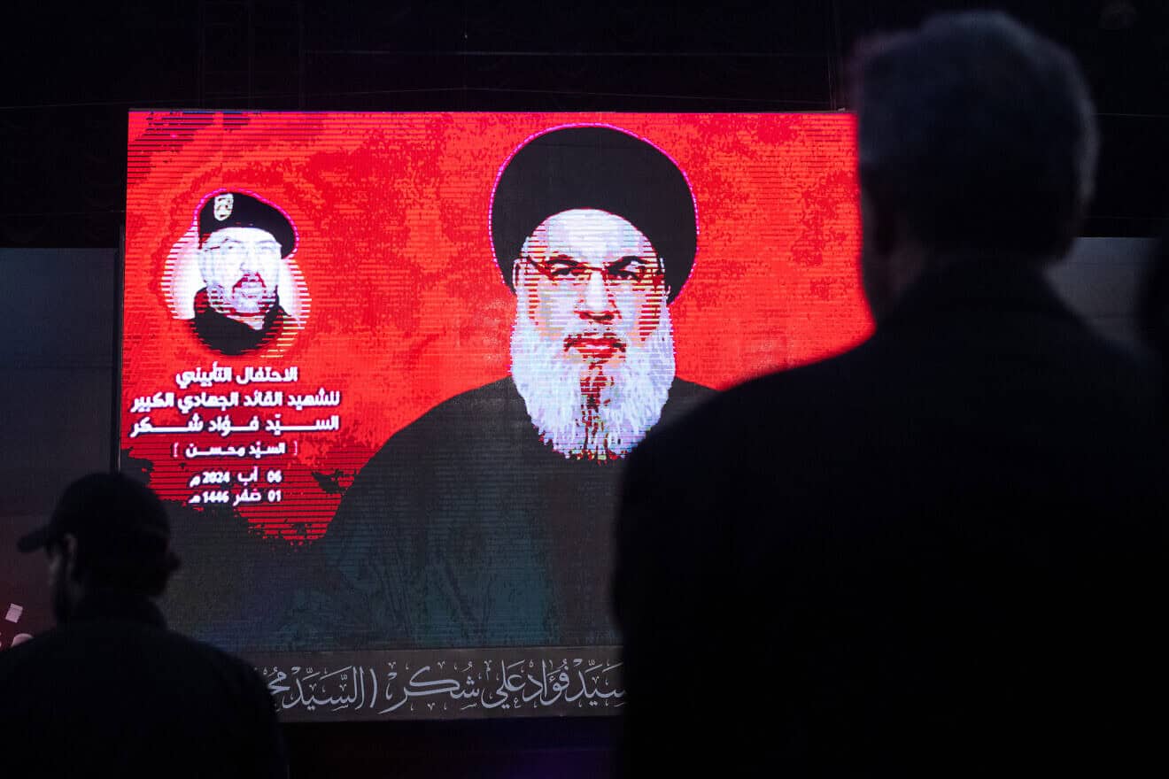Supporters listen to Hezbollah leader Hassan Nasrallah via a video link during a ceremony to mark the first week since the killing of Hezbollah's top commander Fuad Shukr in Beirut, Aug. 6, 2024. Photo by Chris McGrath/Getty Images.