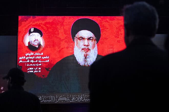 Supporters listen to Hezbollah leader Hassan Nasrallah via a video link during a ceremony to mark the first week since the killing of Hezbollah's top commander Fuad Shukr in Beirut, Aug. 6, 2024. Photo by Chris McGrath/Getty Images.