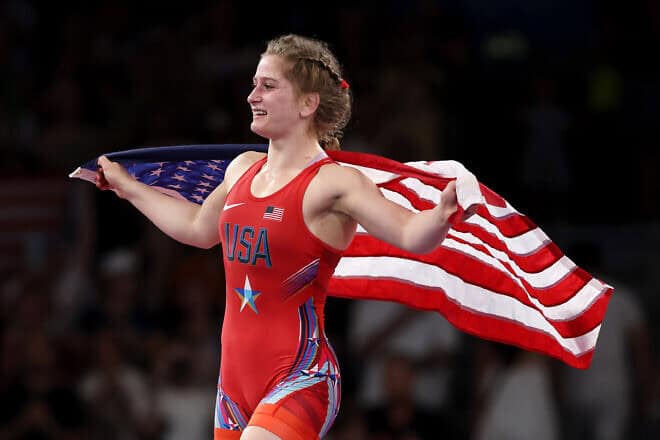 Amit Elor of Team United States celebrates with the United States flag following victory against Meerim Zhumanazarova of Team Kyrgyzstan (not pictured) during the Wrestling Women's Freestyle 68kg Gold Medal match on day eleven of the Olympic Games Paris 2024 at Champs-de-Mars Arena on Aug. 6, 2024 in Paris, France. Photo by Sarah Stier/Getty Images.