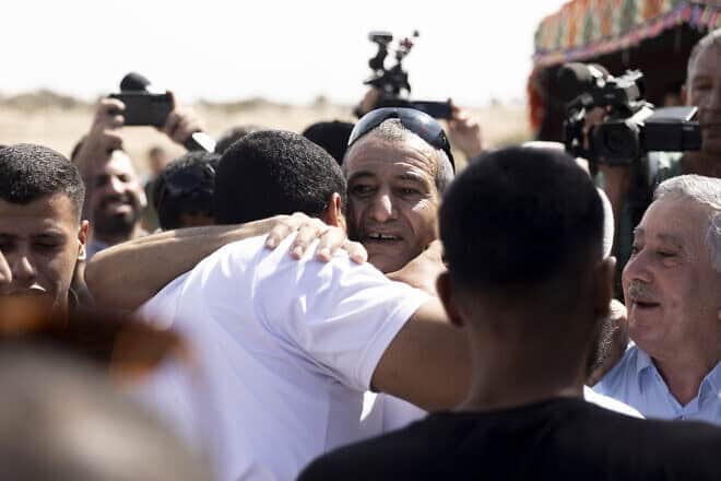 Qaid Farhan Alkadi (center), who was held hostage by Hamas in Gaza, is greeted as he returns to the unrecognized Bedouin village of Carcur, near the city of Rahat, after being rescued by Israeli forces from a tunnel in Southern Gaza, Aug. 28, 2024. Photo by Amir Levy/Getty Images.