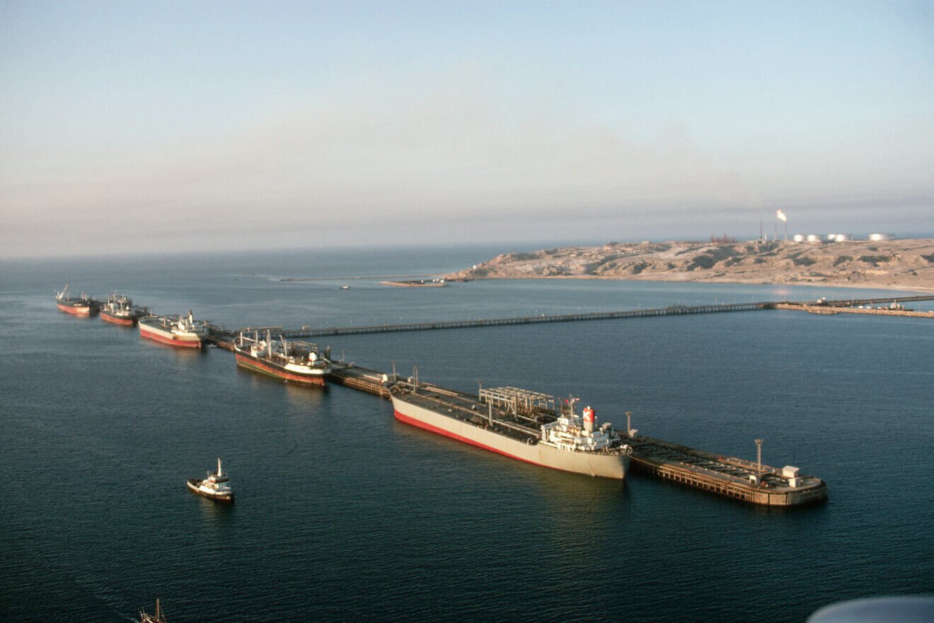 Aerial view of oil tankers at the Khark Island loading terminal at sunrise. The water is shallow in the northern end of the Persian Gulf and oil has to be piped 25 miles out to the island for loading on tankers. Iran, 1968. Photo by Dean Conger/Corbis via Getty Images.