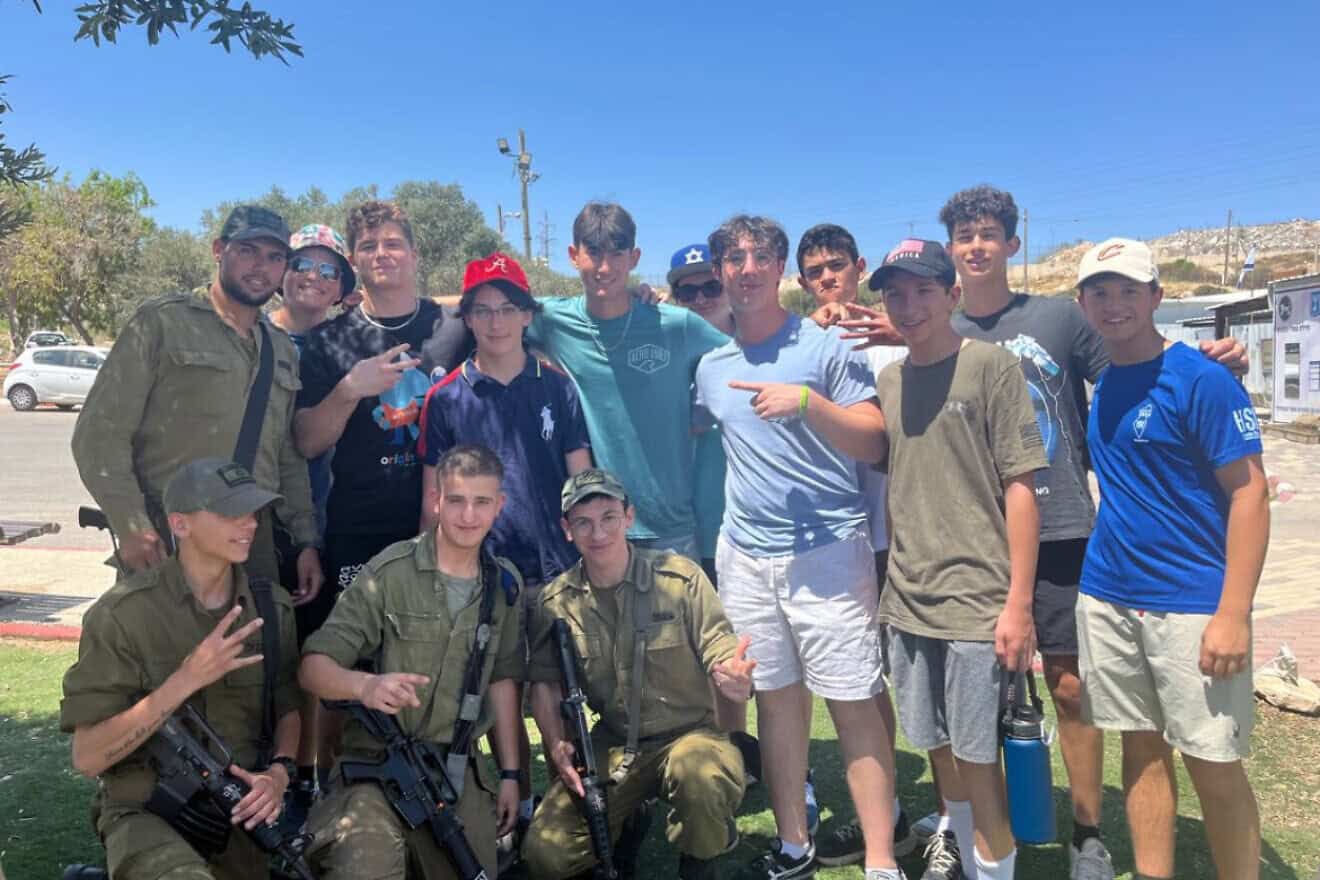 Participants in the Jewish National Fund-USA teen volunteer in Israel mission pose with Israel Defense Forces soldiers in the Negev. Credit: Courtesy.