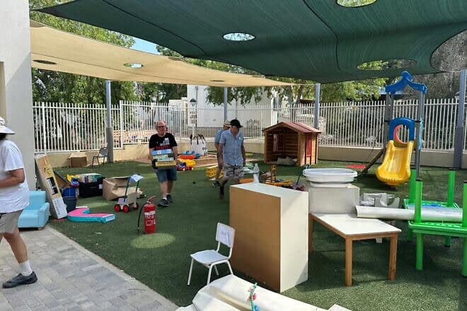 Volunteers set up a kindergarten playground at Kibbutz Nir Am, Aug. 20, 2024. Photo by Debbie Dash.
