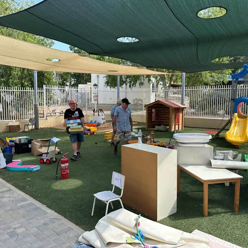 Volunteers set up a kindergarten playground at Kibbutz Nir Am, Aug. 20, 2024. Photo by Debbie Dash.