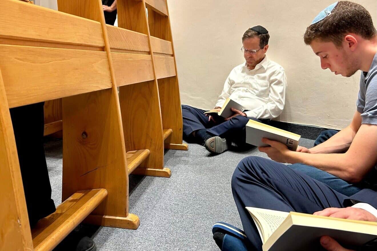 Israeli President Isaac Herzog participates in a reading of the Book of Lamentations at the Ohel Nechama Synagogue in Jerusalem. The book recounts the destruction of the Temple in Jerusalem and is traditionally recited sitting on the floor as a sign of mourning, July 13, 2024. Credit: Courtesy.