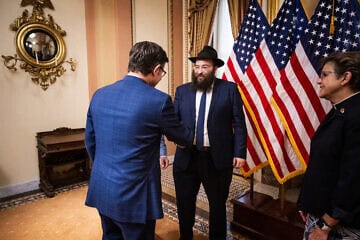 Speaker of the House Mike Johnson greets Rabbi Levi Slonim in the U.S. Capitol in Washington, D.C., as chaplain for the U.S. House of Representatives Margaret Grun Kibben, an American Presbyterian minister, looks on, July 25, 2024. Credit: Courtesy.