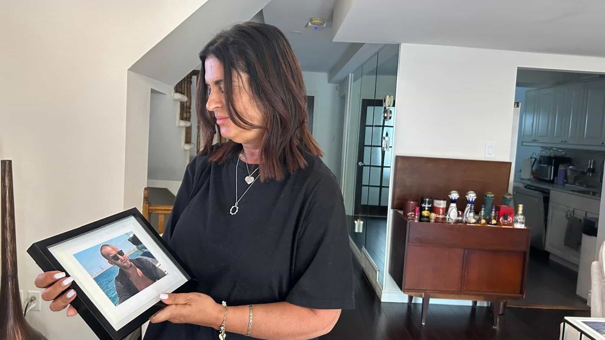 Raquel Ohnona Look holds a portrait of her son Alexandre inside her home in Montreal in August 2024. Photo by Amelie Botbol.