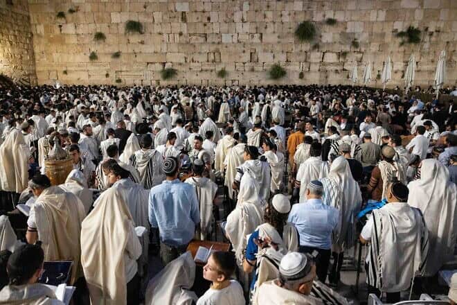 Jewish men pray during Tisha B'Av at the Western Wall in the Old City of Jerusalem, July 27, 2023. Photo by Chaim Goldberg/Flash90.