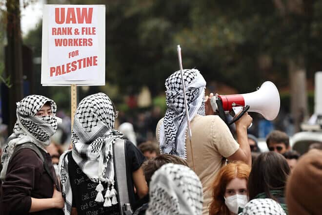 Pro-Palestinian demonstrators gather with a sign reading “UAW Rank & File Workers for Palestine” after police cleared a new encampment of anti-Israel protesters at the University of California, Los Angeles, on May 23, 2024. Photo by Mario Tama/Getty Images.
