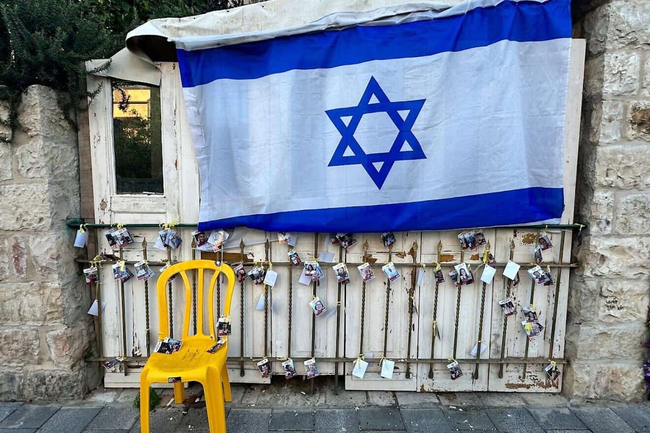 An Israeli flag above photos of hostages being held by Hamas. Credit: Courtesy of Jewish National Fund-USA.