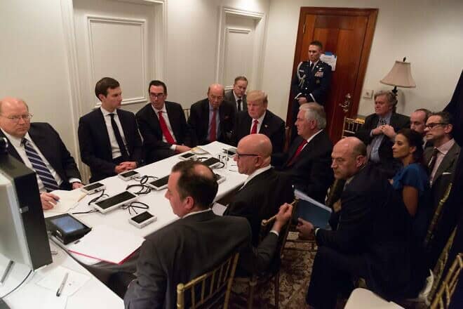 U.S. President Donald Trump receives a briefing on a military strike on Syria from his National Security team, including a video teleconference with U.S. Secretary of Defense Gen. James Mattis, chairman of the Joint Chiefs of Staff Gen. Joseph F. Dunford and National Security Advisor H.R. McMaster, in a secured location at Mar-a-Lago in West Palm Beach, Fla., on April 6, 2017. Credit: White House Photographer Shaleah Craighead via Wikimedia Commons.