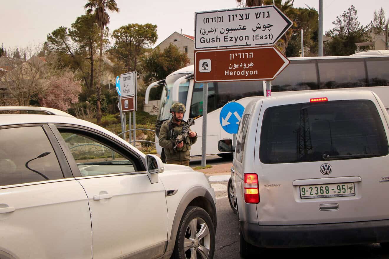 Israeli soldiers stand guard at the entrance to the Jewish community of Efrat in Gush Etzion, March 29, 2022. Photo by Gershon Elinson/Flash90.