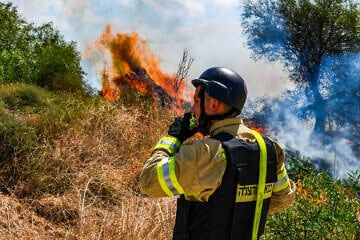A Firefighter at a wildfire following a missile attack from Lebanon, near Kibbutz Snir in the Galilee panhandle, Sept. 16, 2024. Photo by Ayal Margolin/Flash90.