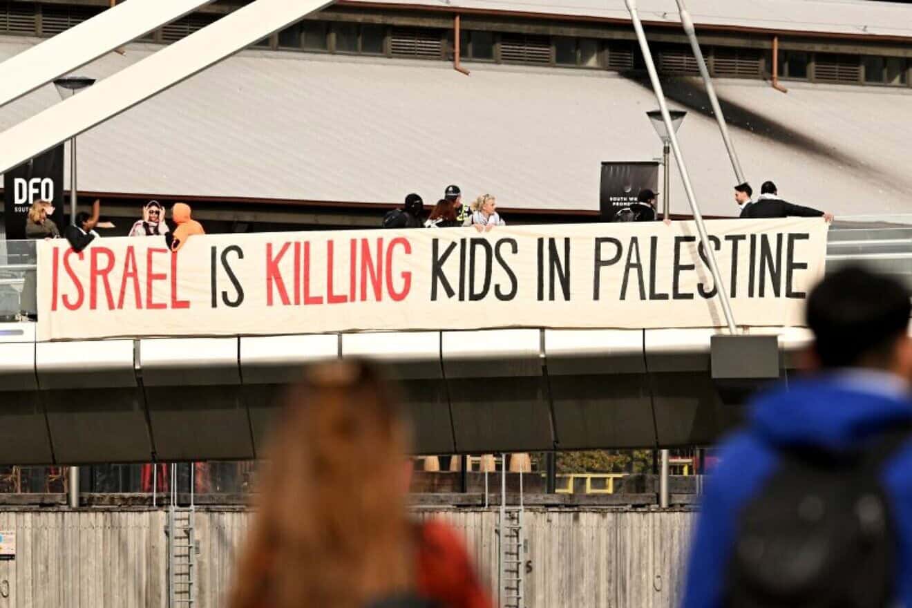 Protesters unfurl a banner outside the Land Forces 2024 arms fair in Melbourne on Sept. 11, 2024. Photo by William West/AFP via Getty Images.