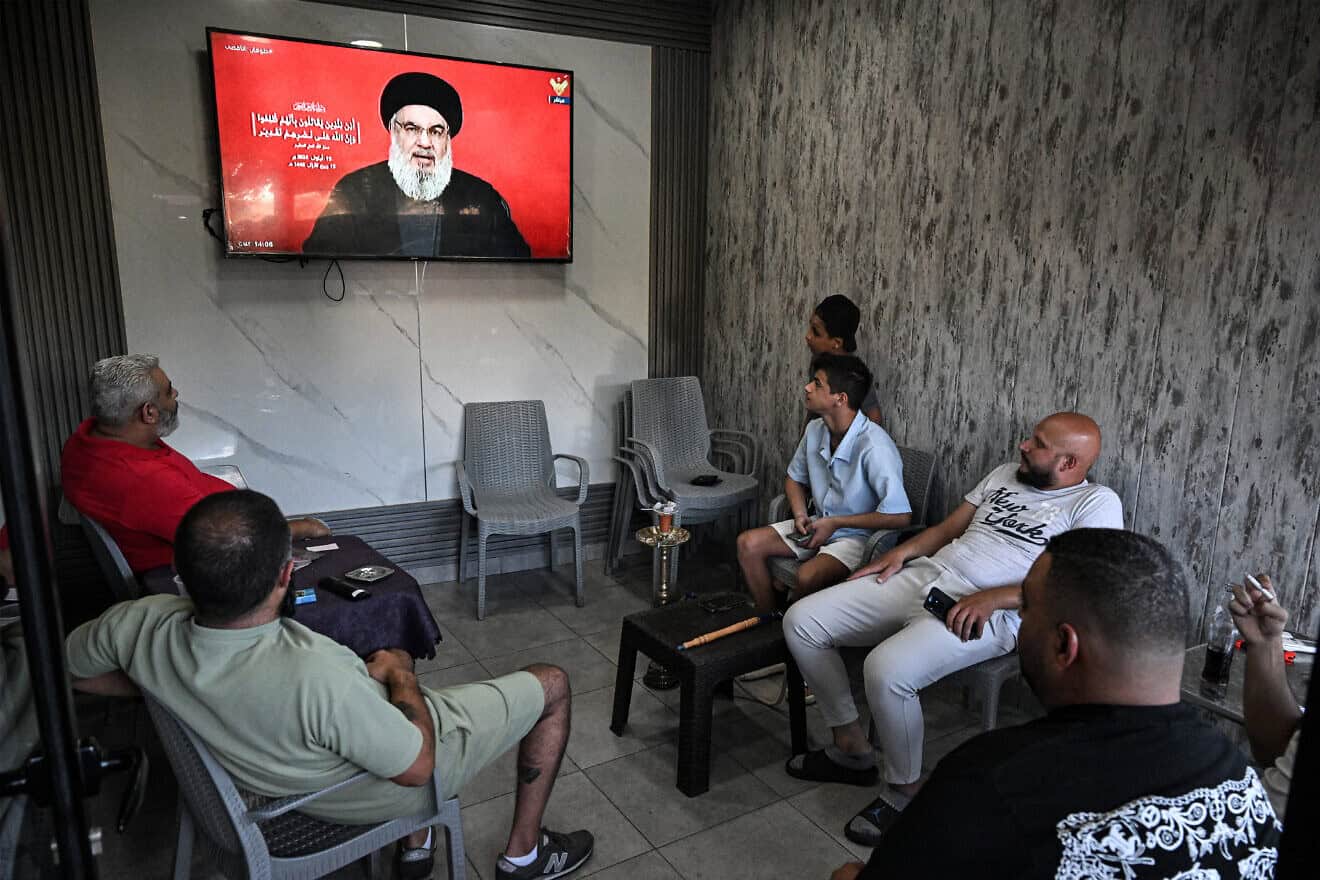People watch a televised speech by Hezbollah chief Hassan Nasrallah in a southern suburb of Beirut on Sept. 19, 2024. Photo by Joseph Eid/AFP via Getty Images.