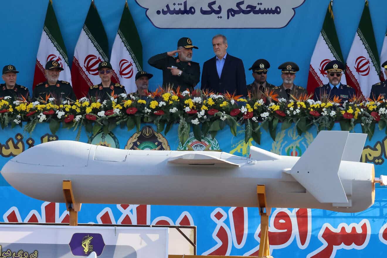 Iranian President Masoud Pezeshkian (R) and commander of the Islamic Revolutionary Guard Corps' Aerospace Force Amir Ali Hajizadeh look on as Iran's new Shahed 136-B drone is displayed during the annual military parade marking the anniversary of the outbreak of the 1980-1988 war with Saddam Hussein's Iraq, in Tehran on Sept. 21, 2024. Photo by Atta Kenare/ AFP via Getty Images.