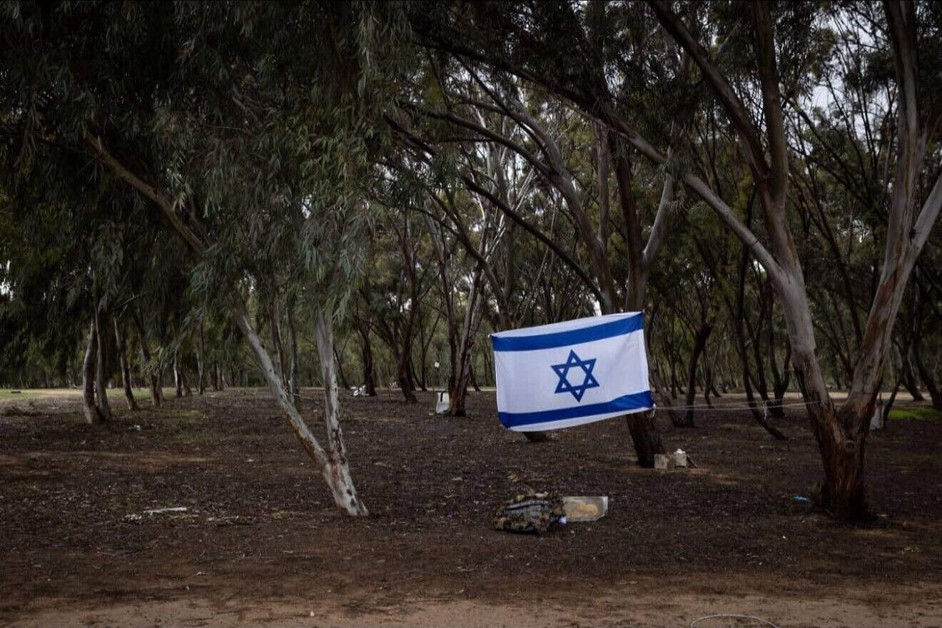 An Israeli flag in Re'im, the site of the Nova music festival in southern Israel near the border with the Gaza Strip, which was attacked by Hamas terrorists who slaughtered 364 people there on Oct. 7, 2023. Credit: Alex Kolomoisky, KKL-JNF.