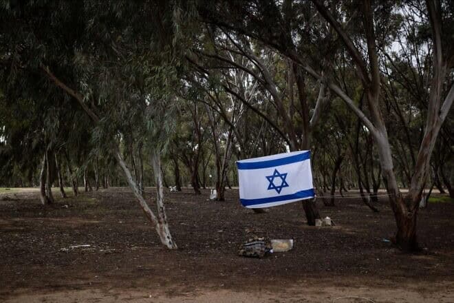 An Israeli flag in Re'im, the site of the Nova music festival in southern Israel near the border with the Gaza Strip, which was attacked by Hamas terrorists who slaughtered 364 people there on Oct. 7, 2023. Credit: Alex Kolomoisky, KKL-JNF.
