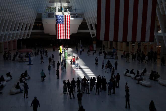 People walk through the “Way of Light” that forms inside the Oculus transit hub as the sun passes through the glass roof at 10:28 a.m., the time the second tower of the World Trade Center collapsed during the 9/11 attacks in New York City on Sept. 11, 2024. Photo by Gary Hershorn/Getty Images.
