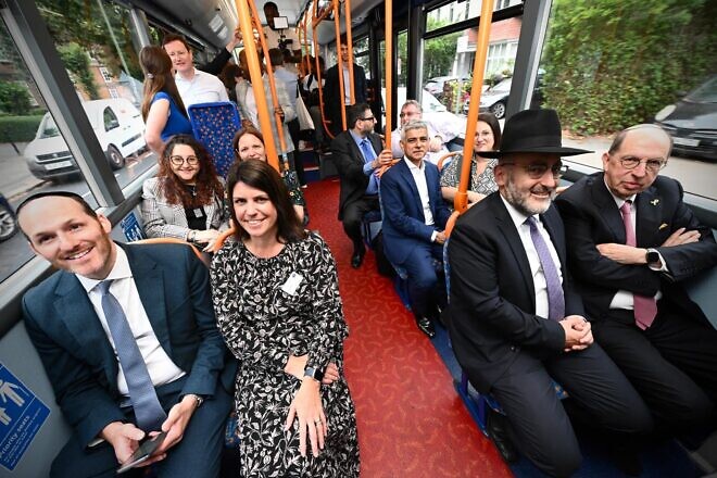 A 310 bus line, launched in September 2024 in London, connects Jewish communities in Golders Green and Stamford Hill. Sadiq Khan, the London mayor, is seated in the middle without a tie. Credit: London Jewish Forum.