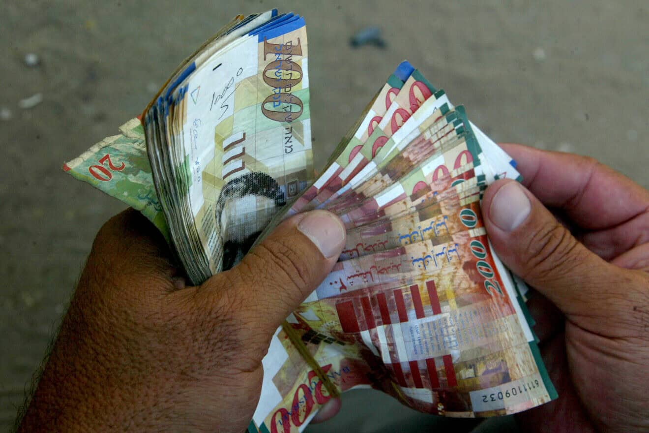 A Palestinian man withdraws Israeli shekels from a Bank of Palestine ATM in Rafah, the southernmost city in the Gaza Strip, July 6, 2009. Photo by Abed Rahim Khatib/Flash90.