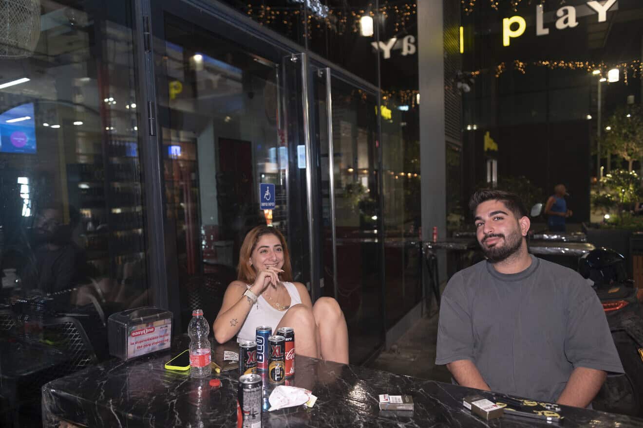Noam Swissa (left) and Asif Korliker sit outside their hotel in Tel Aviv on Sept. 7, 2024. Photo by Canaan Lidor.