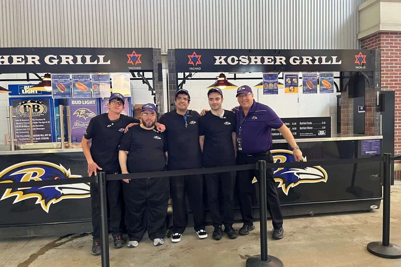 Participants from the Orthodox Union's Yachad program work with supervisors to serve up kosher food at Baltimore Ravens games. Credit: Courtesy.