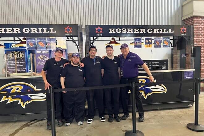 Participants from the Orthodox Union's Yachad program work with supervisors to serve up kosher food at Baltimore Ravens games. Credit: Courtesy.