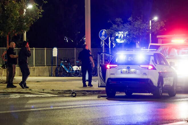 Israeli security forces at the scene where a fragment of a missile fired from Lebanon fell on a main road in Herzliya, Oct. 7, 2024. Photo by Tal Gal/Flash90.