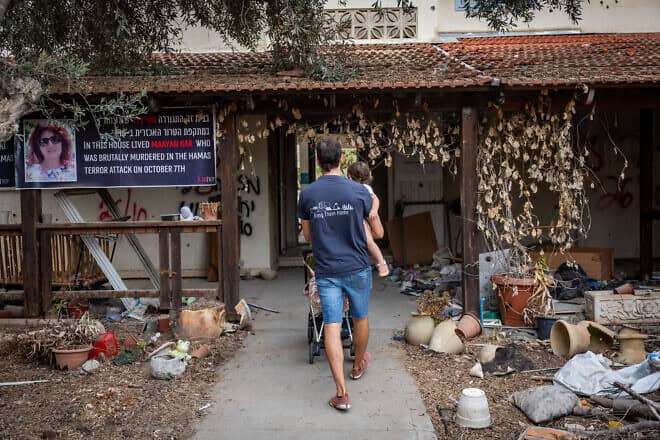 Family members and friends visit in Kibbutz Beeri, a year after the October 7 massacre,  Oct. 7, 2024. Photo by Yonatan Sindel/Flash90.