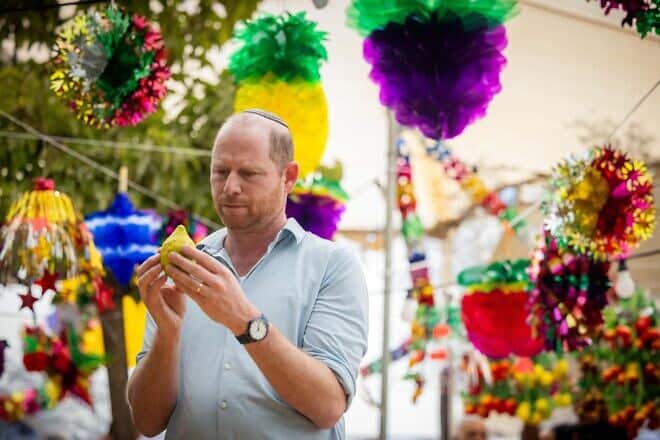 Ahead of Sukkot, Israelis shop for "Four Species" at stands set up outside the Machane Yehuda outdoor market in Jerusalem, Oct. 14 , 2024. Photo by Yonatan Sindel/Flash90.
