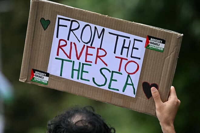 A pro-Palestinian activist holds a placard reading “From the river to the sea" as they march through London during a "National Day of Action for Palestine“ on Sept. 7, 2024. Photo by Justin Tallis/AFP via Getty Images.
