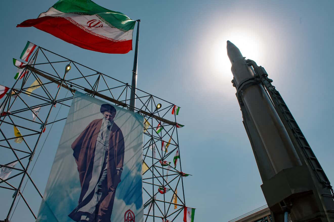 A banner depicting Iran's supreme leader, Ayatollah Ali Khamenei, is placed next to a ballistic missile in Baharestan Square in Tehran, Sept. 26, 2024. Photo by Hossein Beris/Middle East Images/AFP via Getty Images.