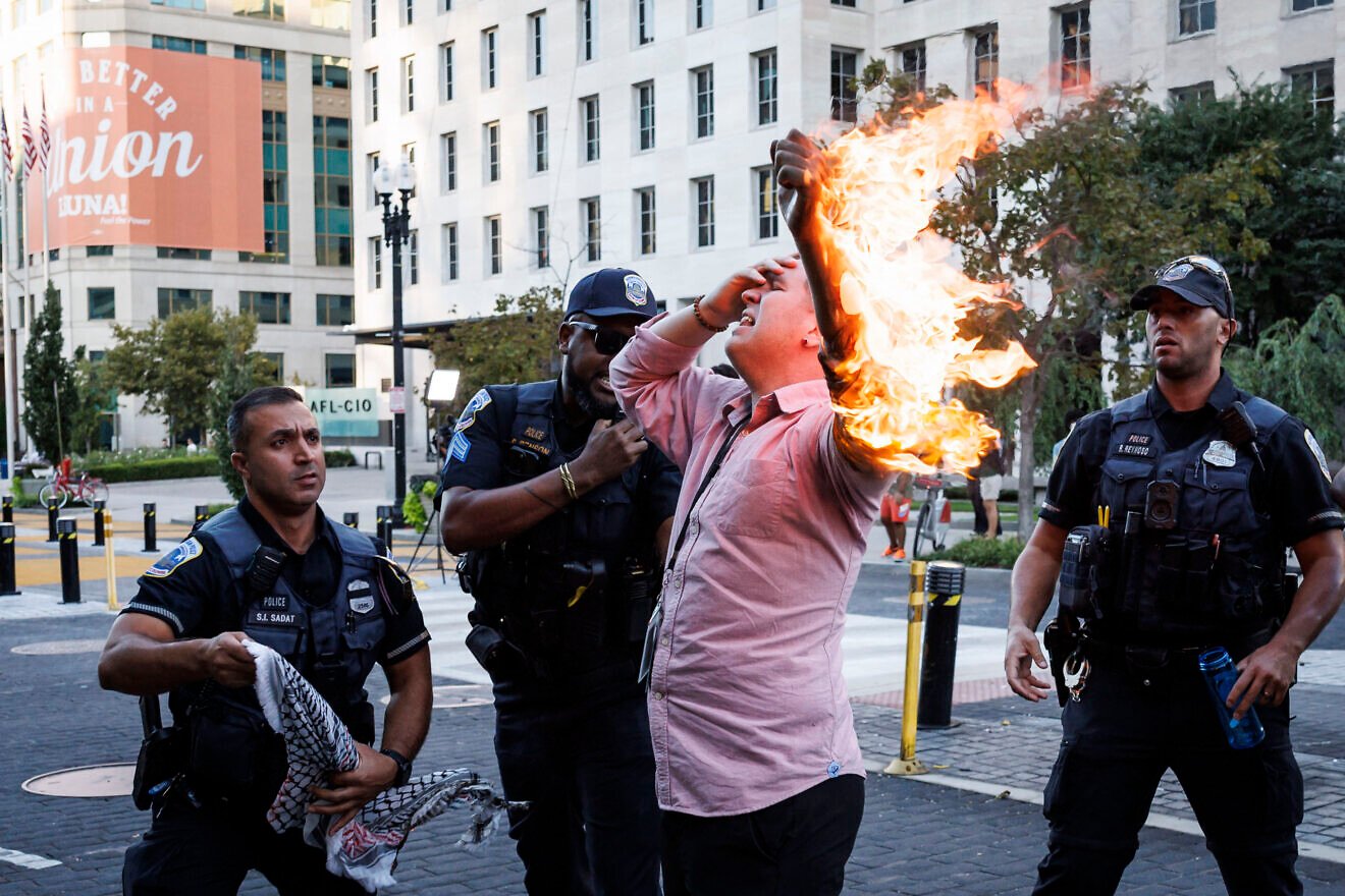 Police help a man who tried to set himself on fire during an anti-Israel demonstration, marking the one-year anniversary of Hamas's Oct. 7, 2023, terror attack on southern Israel, near the White House in Washington, D.C. on Oct. 5, 2024. Photo by Ting Shen/AFP via Getty Images.