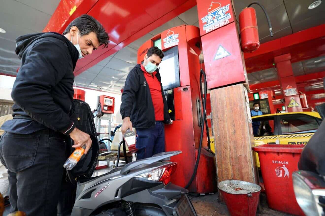 A gas station attendant fills a motorcycle in Tehran after a cyberattack disrupted Iran's fuel distribution network, Oct. 27, 2021. Photo by Atta Kenare/AFP via Getty Images.