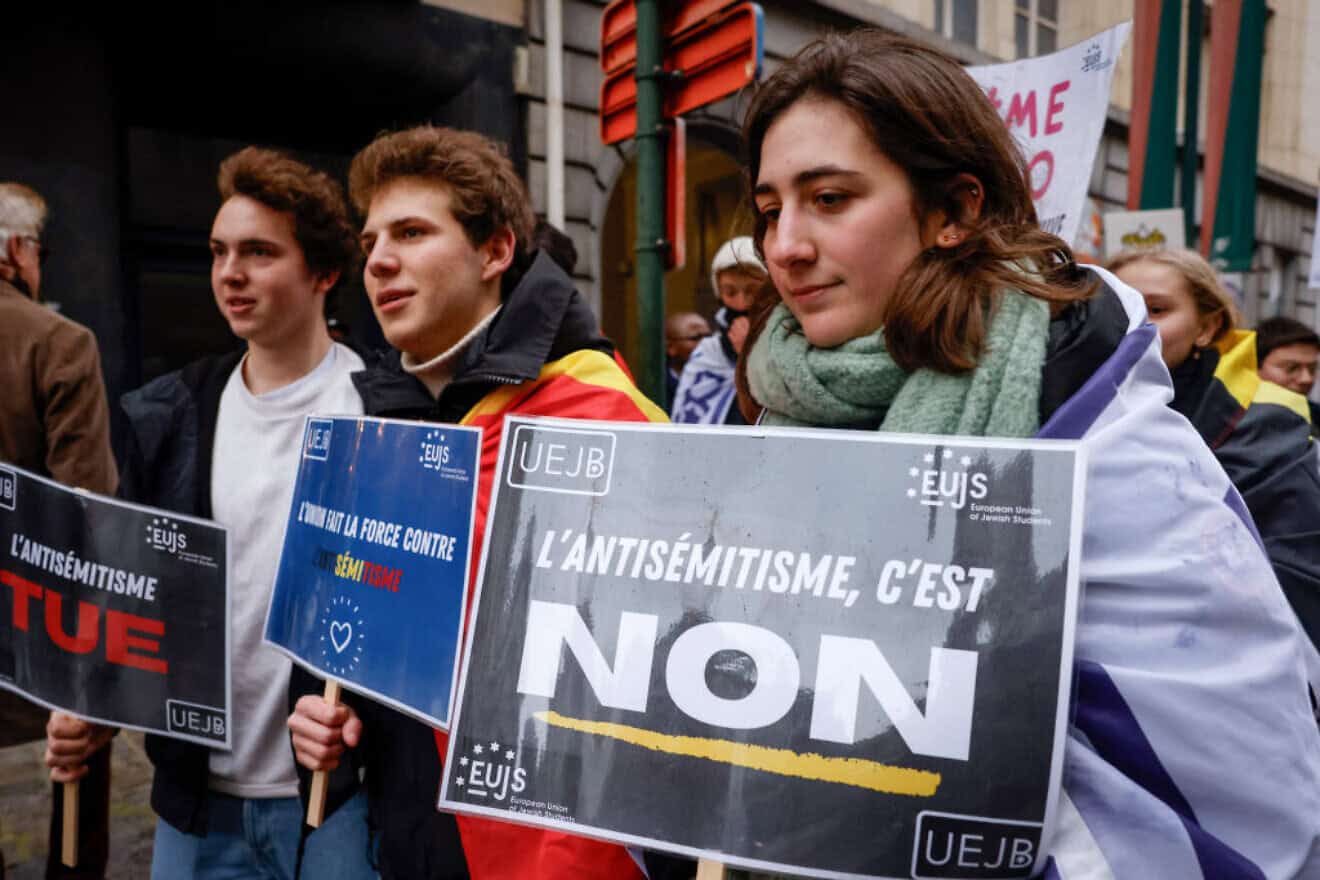 A woman holds a European Union of Jewish Students (EUJS) placard that reads, "Antisemitism, it's no," during a march in central Brussels, part of national protests called by the Belgian League Against Anti-Semitism, on Dec. 10, 2023. Photo by Simon Wohlfahrt/AFP via Getty Images.