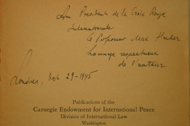 A handwritten dedication by Raphael Lemkin in a copy of his 1944 book “Axis Rule in Occupied Europe,” which defined the term genocide, to Max Huber, president of the International Committee of the Red Cross (ICRC), dated Oct. 29, 1945. Credit: Roman Deckert/Preserved in the ICRC Library.