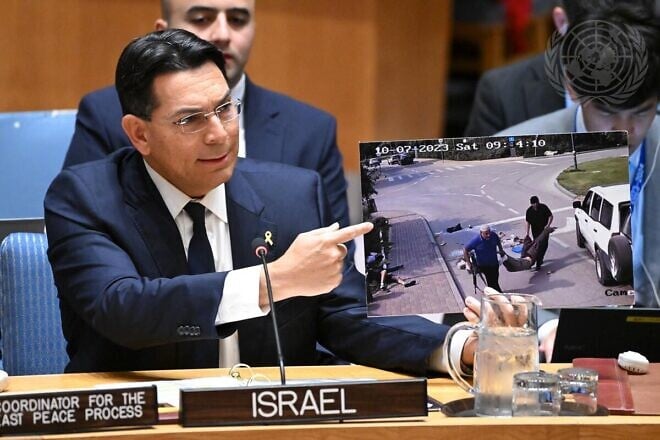 Danny Danon, Israeli ambassador to the United Nations, shows a photo of an UNRWA worker helping kidnap the slain body of Yonatan Samerano during the Hamas-led attacks in Israel on Oct. 7, 2023, at the U.N. Security Council in New York, on Oct. 29, 2024. Credit: Evan Schneider/U.N. Photo.
