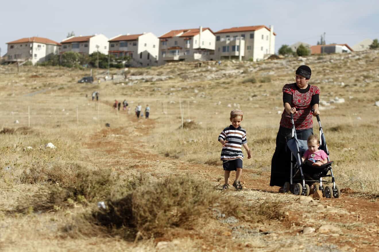 A woman and her children walk towards the town of Kochav HaShahar in the Binyamin region of Samaria, June 4, 2009. Photo by Abir Sultan /Flash90.