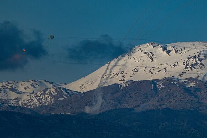Smoke from a Hezbollah rocket rises near Mount Hermon in the Golan Heights, Israel, on March 10, 2024. Photo by Ayal Margolin/Flash90.