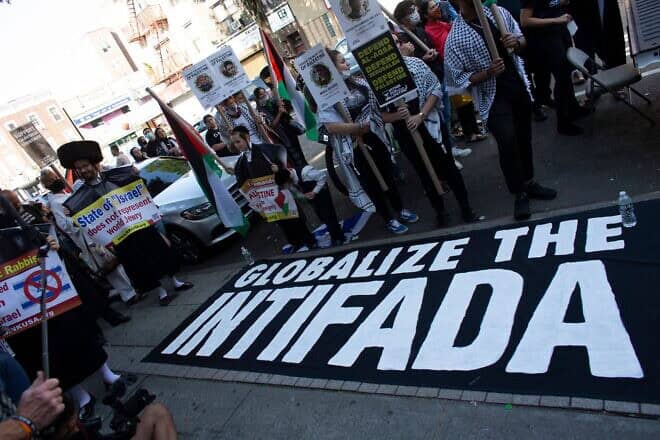 A sign reading "Globalize the Intifada" is seen on the ground in Brooklyn, N.Y., on July 31, 2021. Photo by Kena Betancur/AFP via Getty Images.